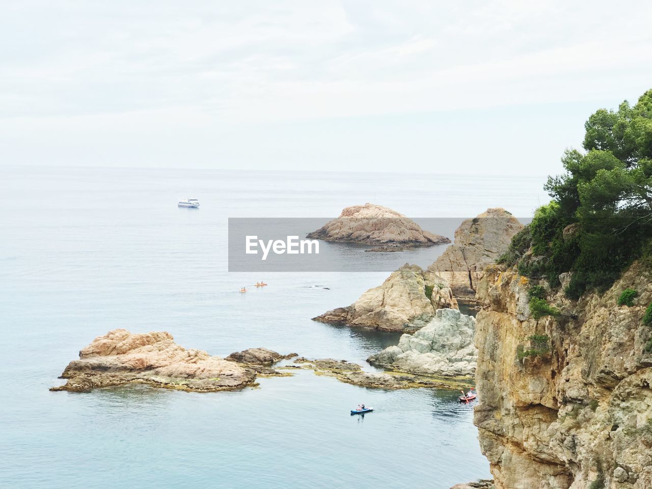 High angle view of rocky shore against sky