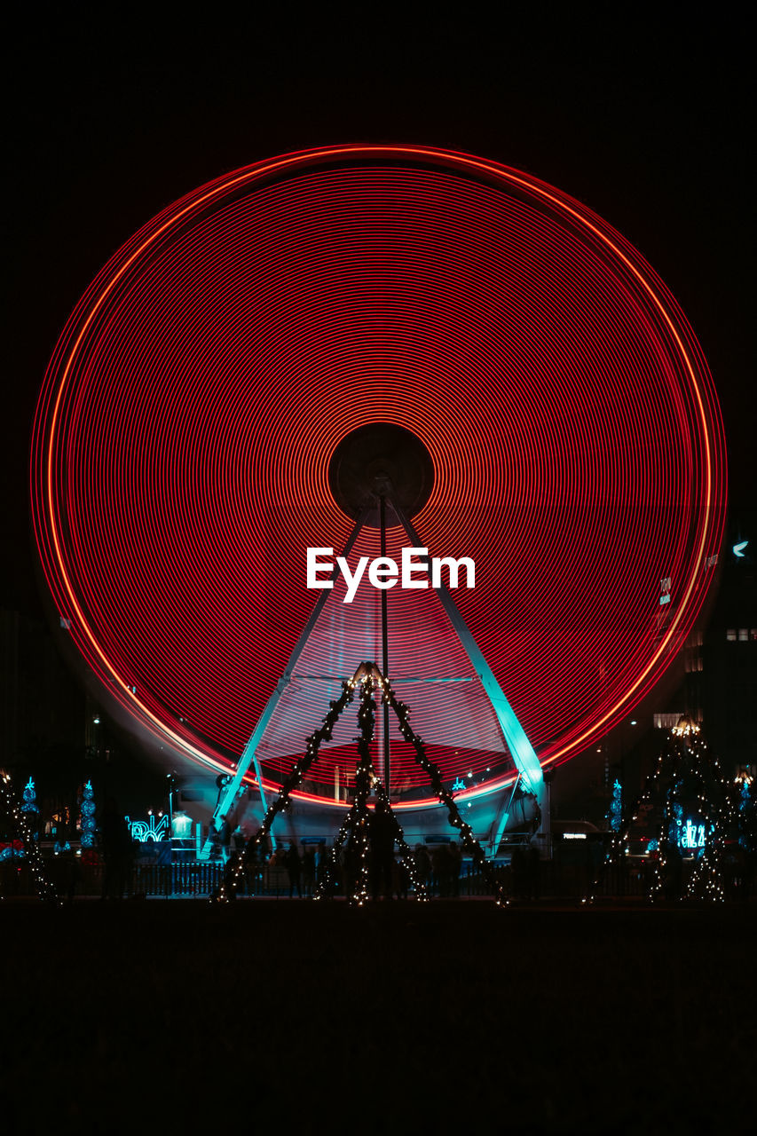 Illuminated ferris wheel at night