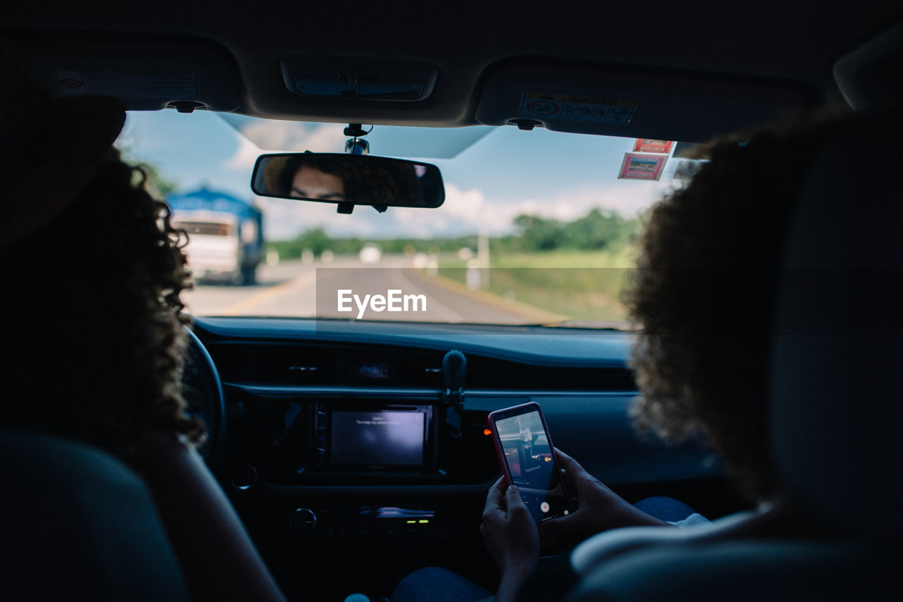 Side view of woman sitting in car