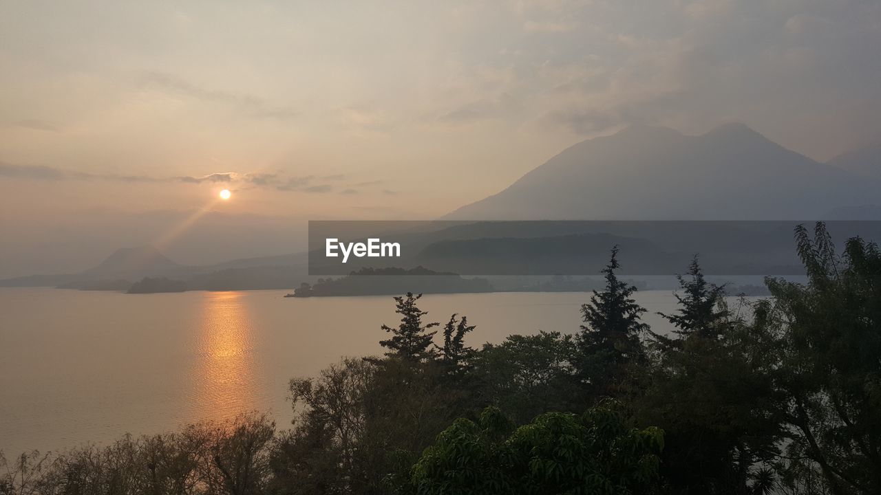 Scenic view of lake and mountains during sunset