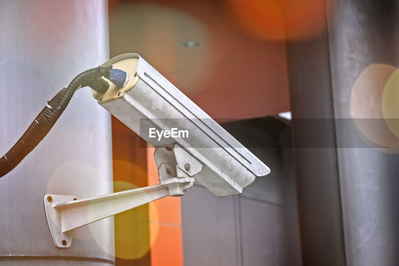 Close-up of security camera mounted on wall