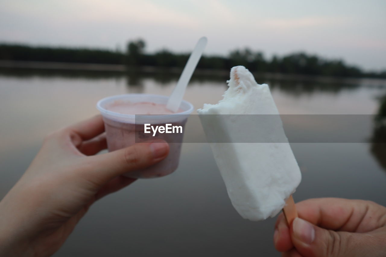 MIDSECTION OF PERSON HOLDING ICE CREAM