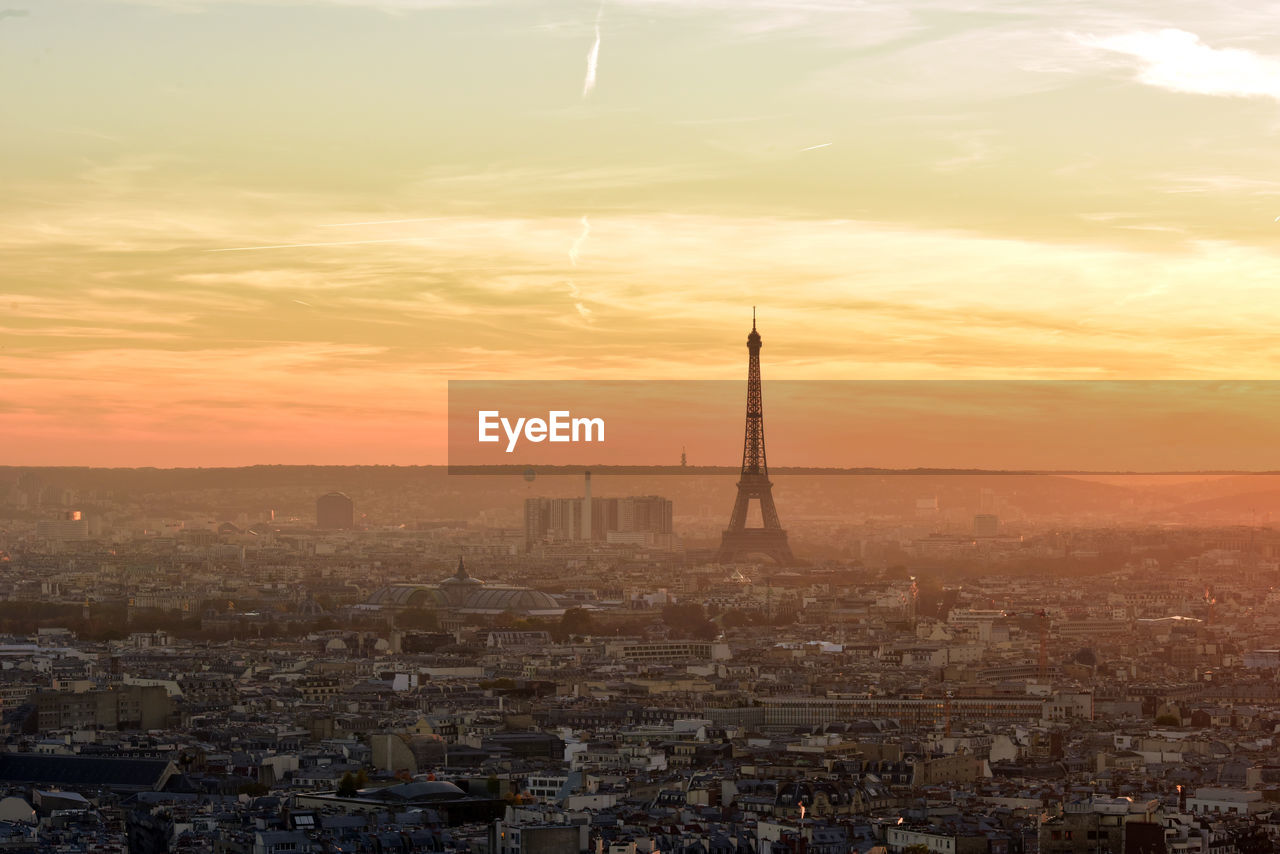 Mid distance view of silhouette eiffel tower against sky during sunset