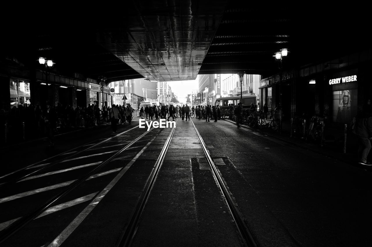 PEOPLE WALKING ON RAILROAD TRACK AT NIGHT