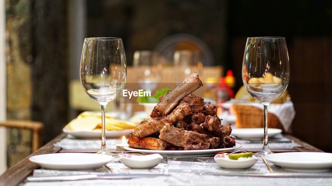 Close-up of food served with wine on table