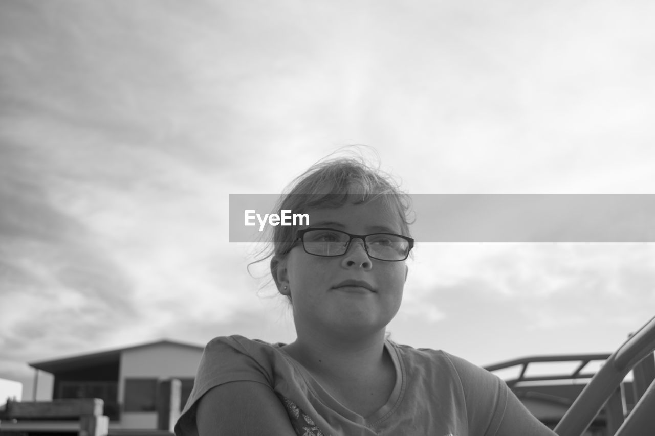 Close-up of girl against sky