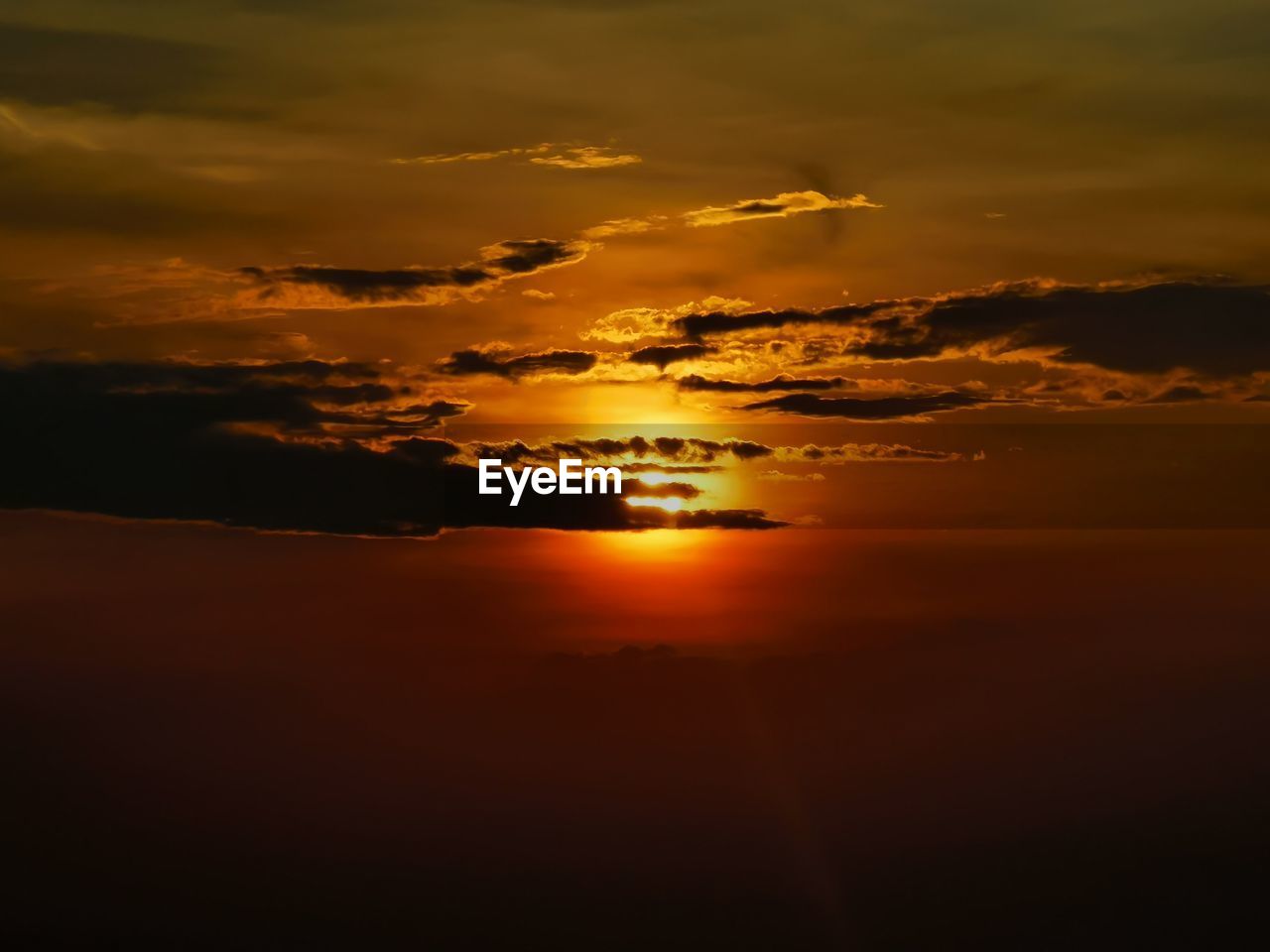 Scenic view of dramatic sky over sea during sunset