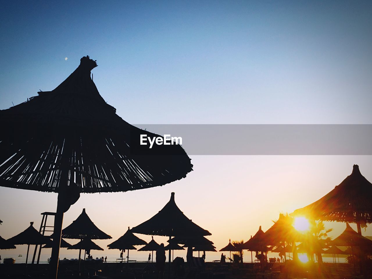 SILHOUETTE PEOPLE AT BEACH AGAINST CLEAR SKY