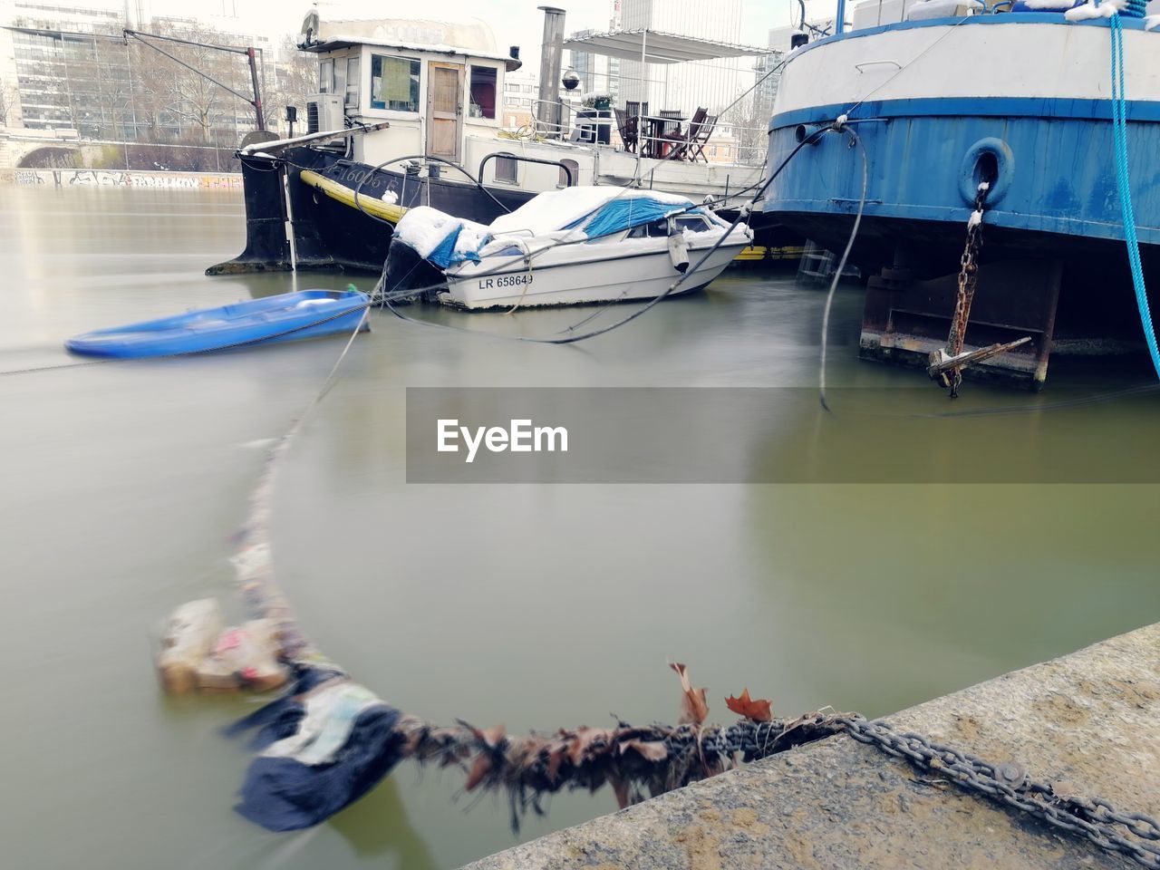 BOATS MOORED IN HARBOR