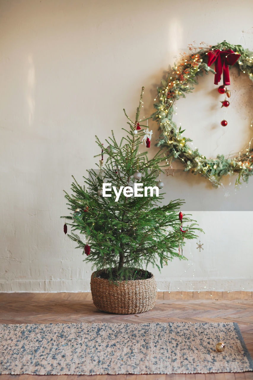 Close-up of christmas tree against wall at home