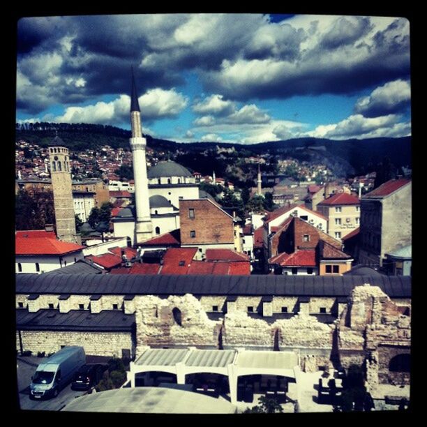 TOWN AGAINST CLOUDY SKY