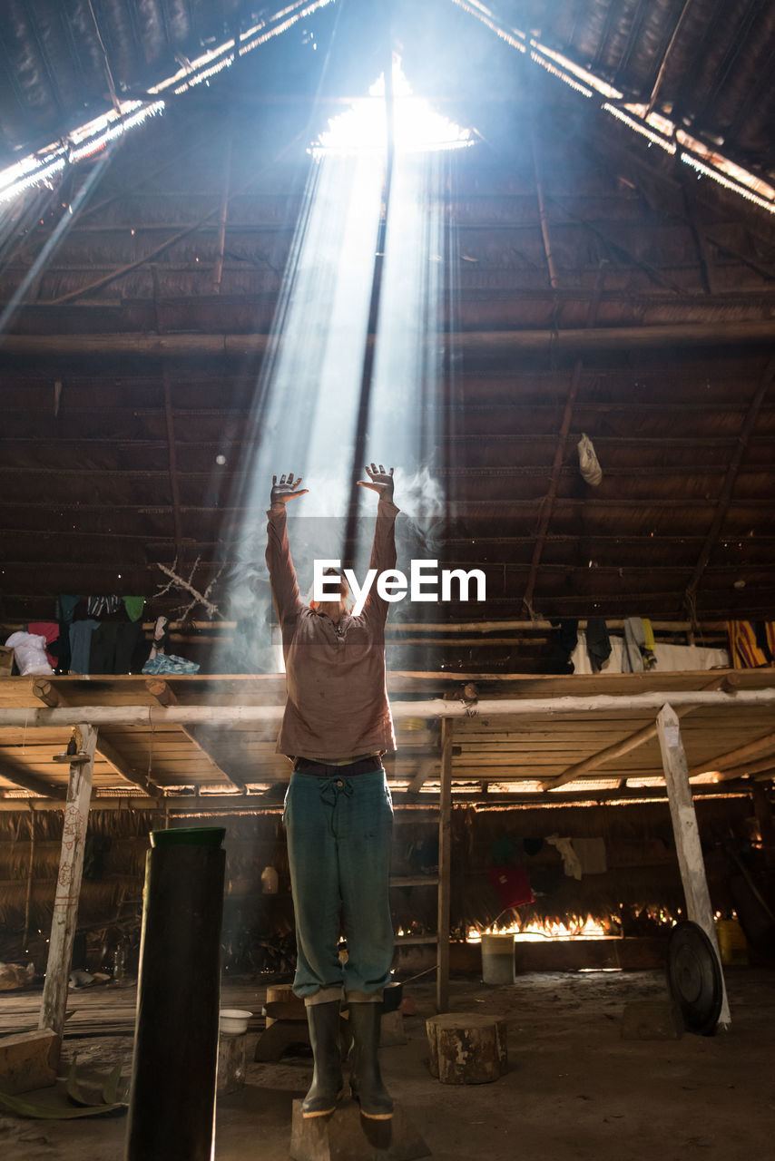 one person, adult, stage, performance, full length, standing, indoors, arms raised, arm, occupation, performance art, men, person, limb, clothing, front view, lens flare, human limb, skill, casual clothing, industry, young adult, working