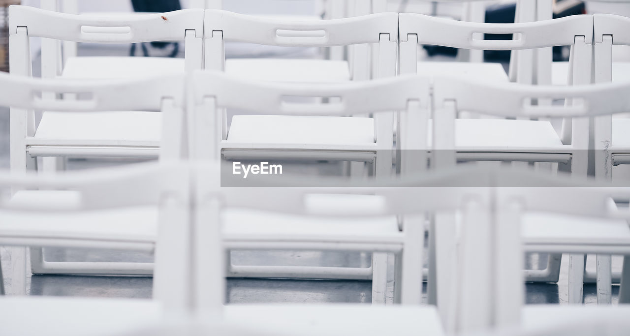 Close-up of chairs on table