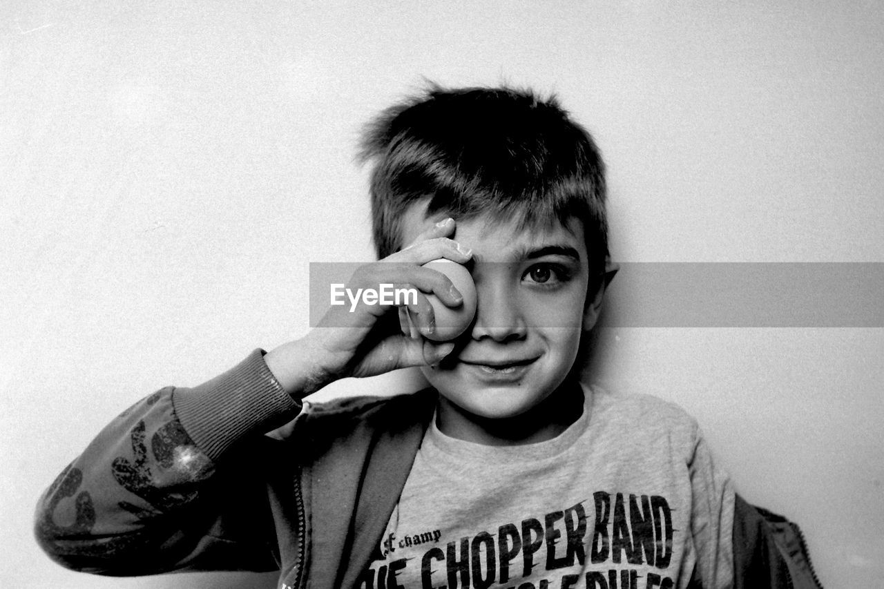 Portrait of smiling boy with egg