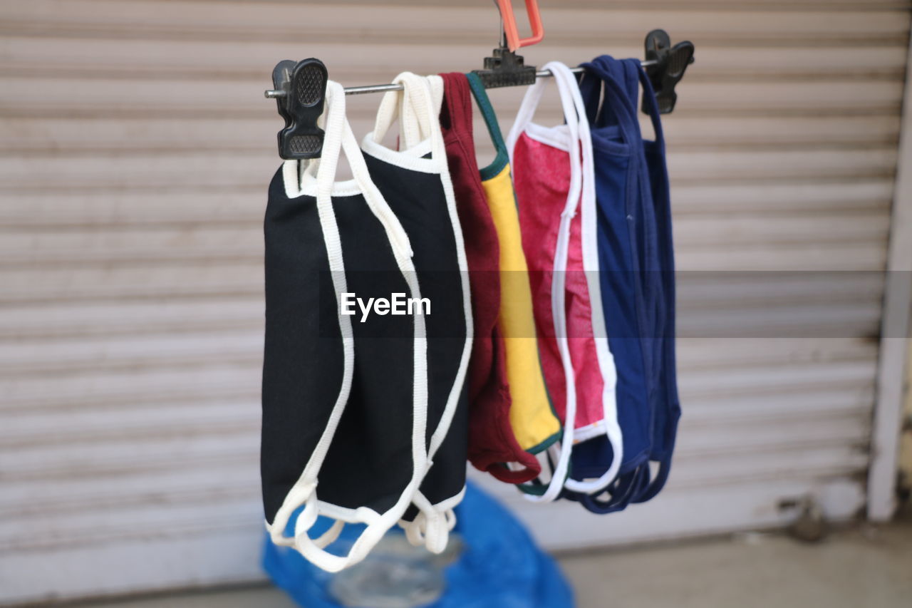 Close-up of clothes hanging on wall