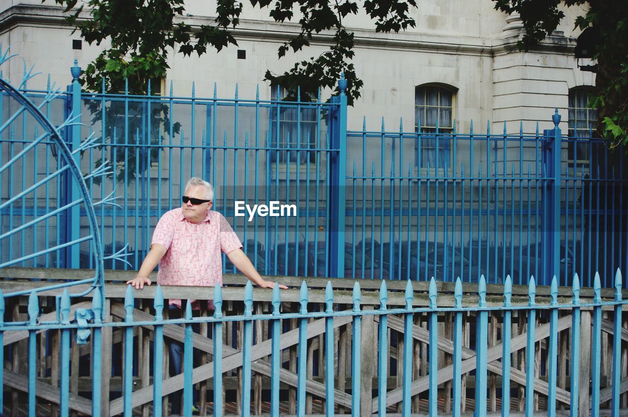 Man standing by fence