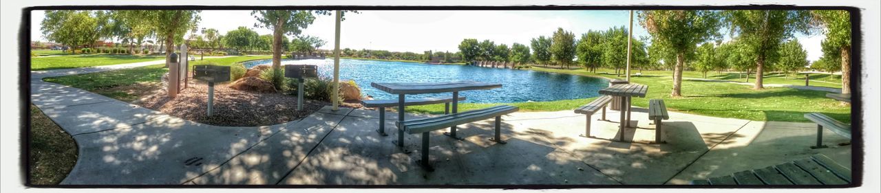 Panoramic view of empty bench near lake