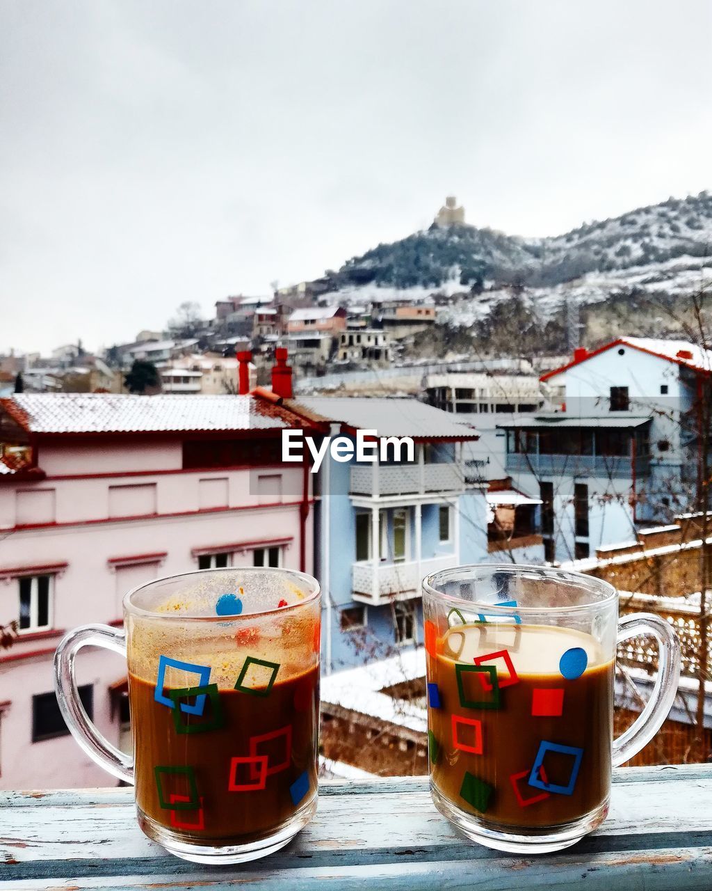 CLOSE-UP OF SNOW AGAINST BUILDINGS