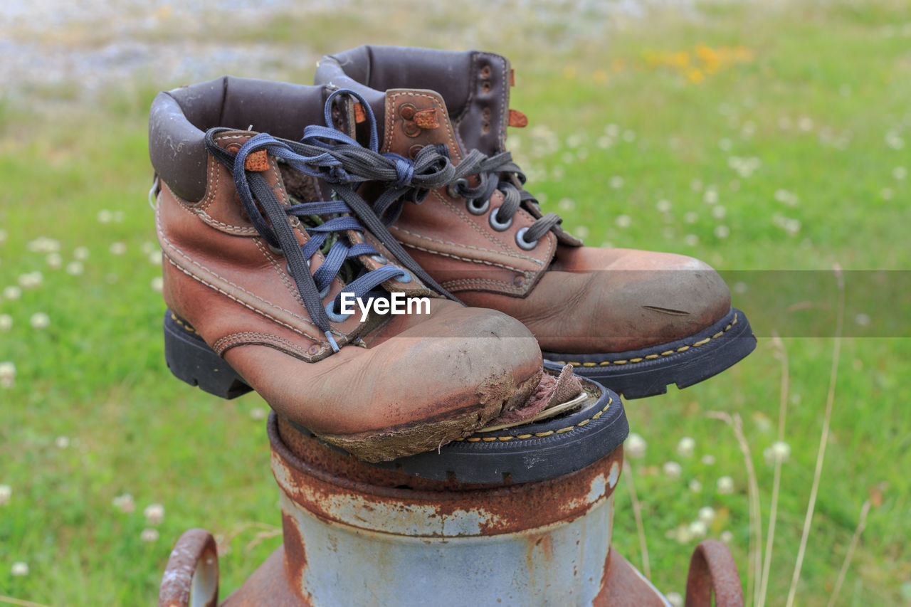 LOW SECTION OF MAN WEARING SHOES ON FIELD