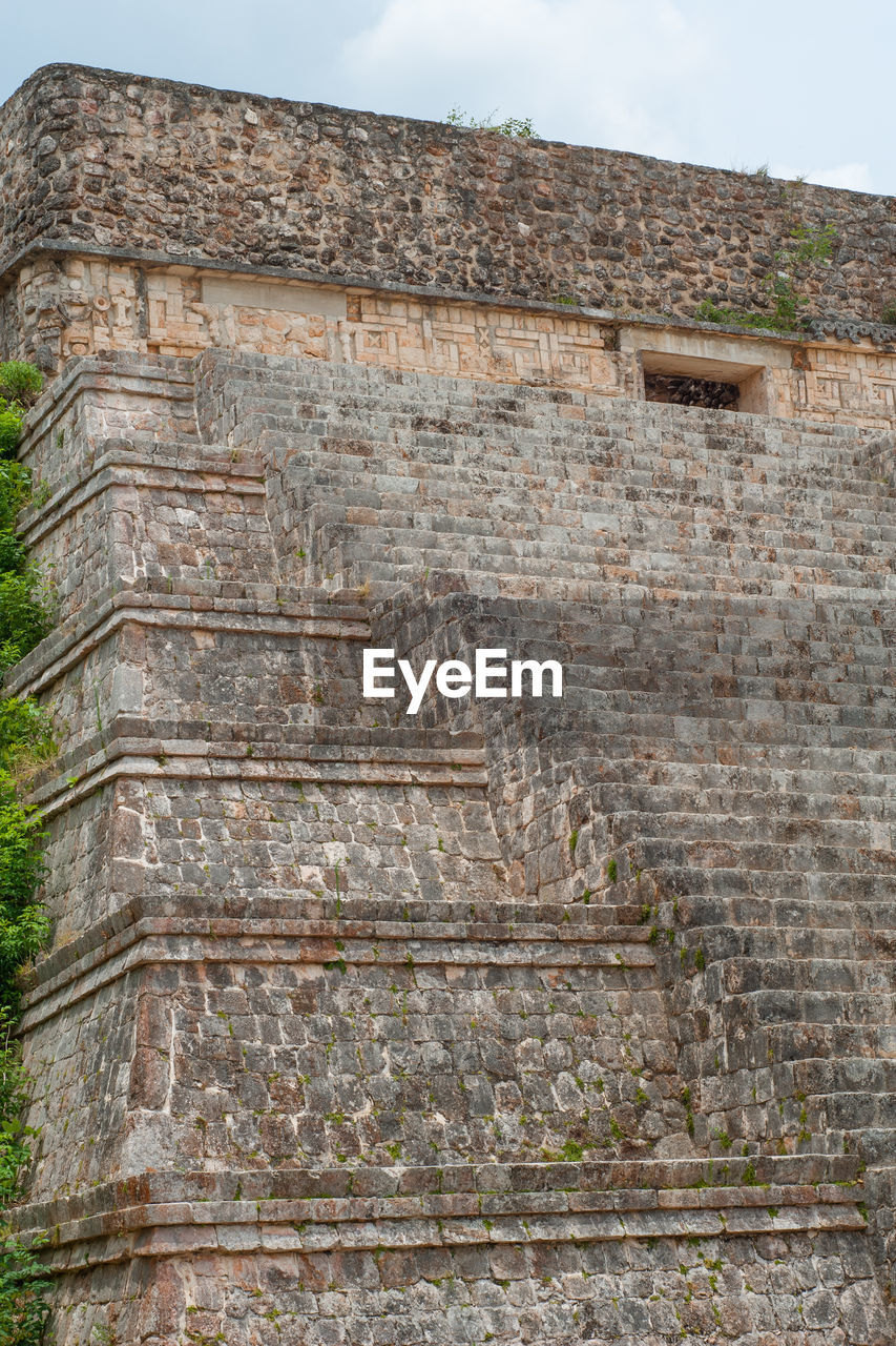 LOW ANGLE VIEW OF WEATHERED BUILDING