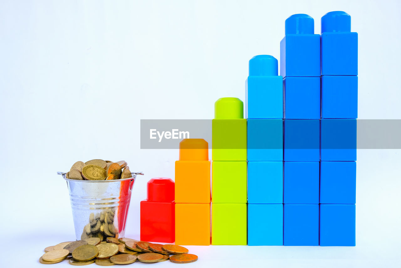 Business graph and chart content. colorful plastic building blocks on white background