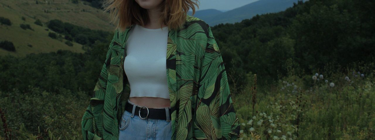 Midsection of woman standing on field