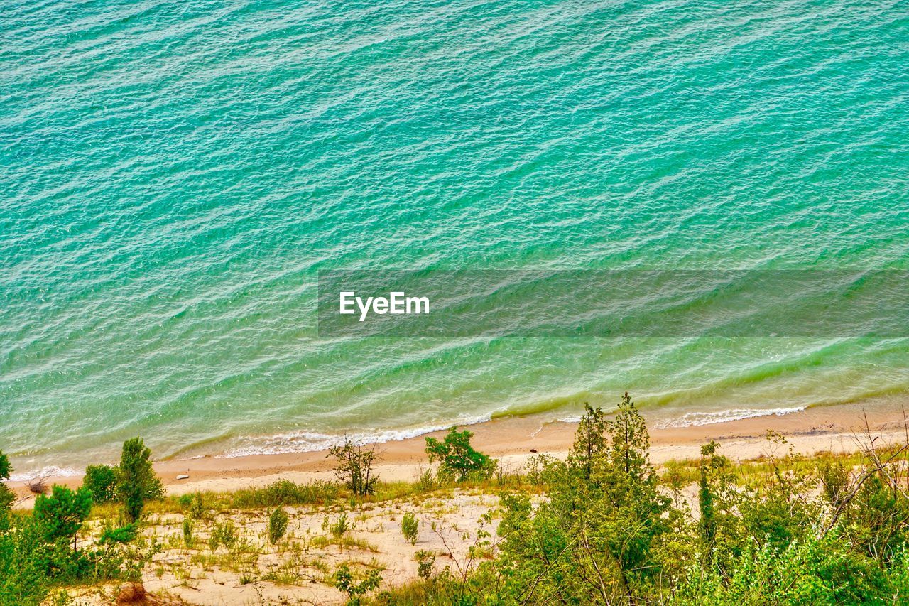 High angle view of trees by sea against sky