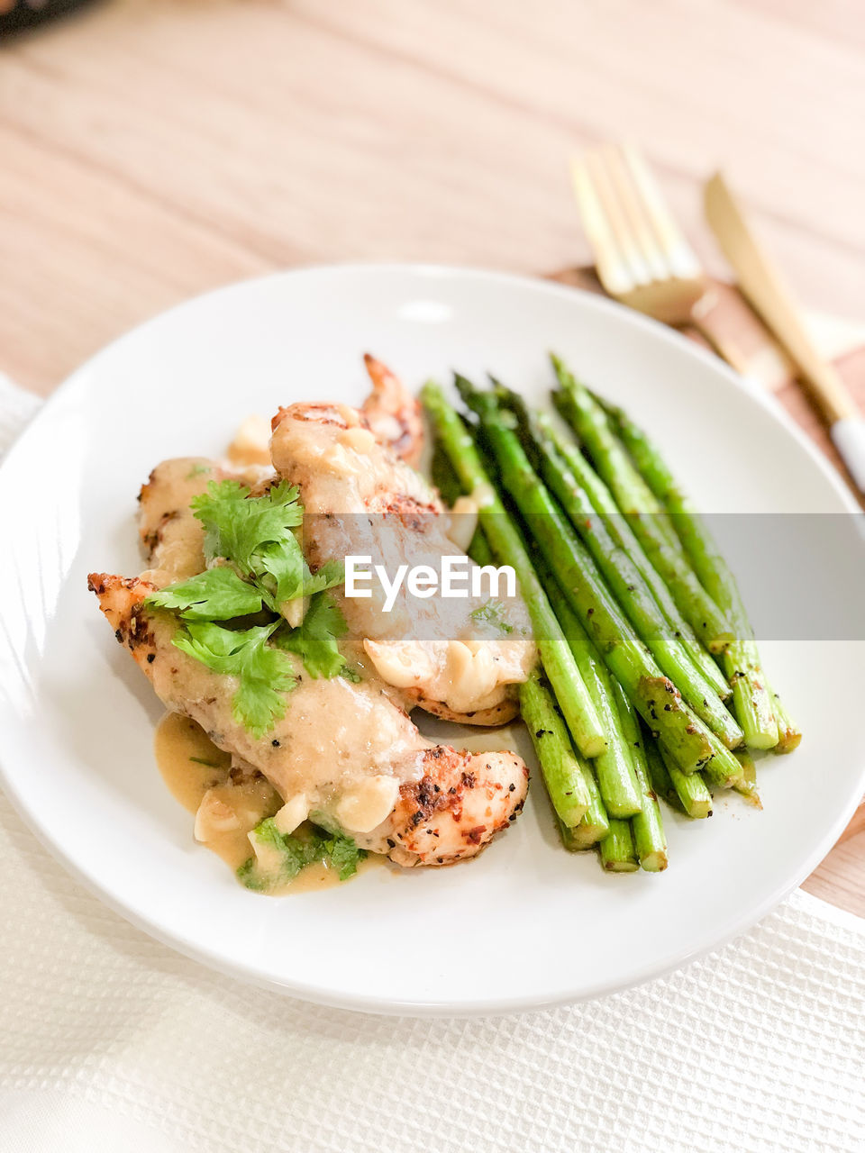 High angle view, grilled chicken and asparagus on white plate