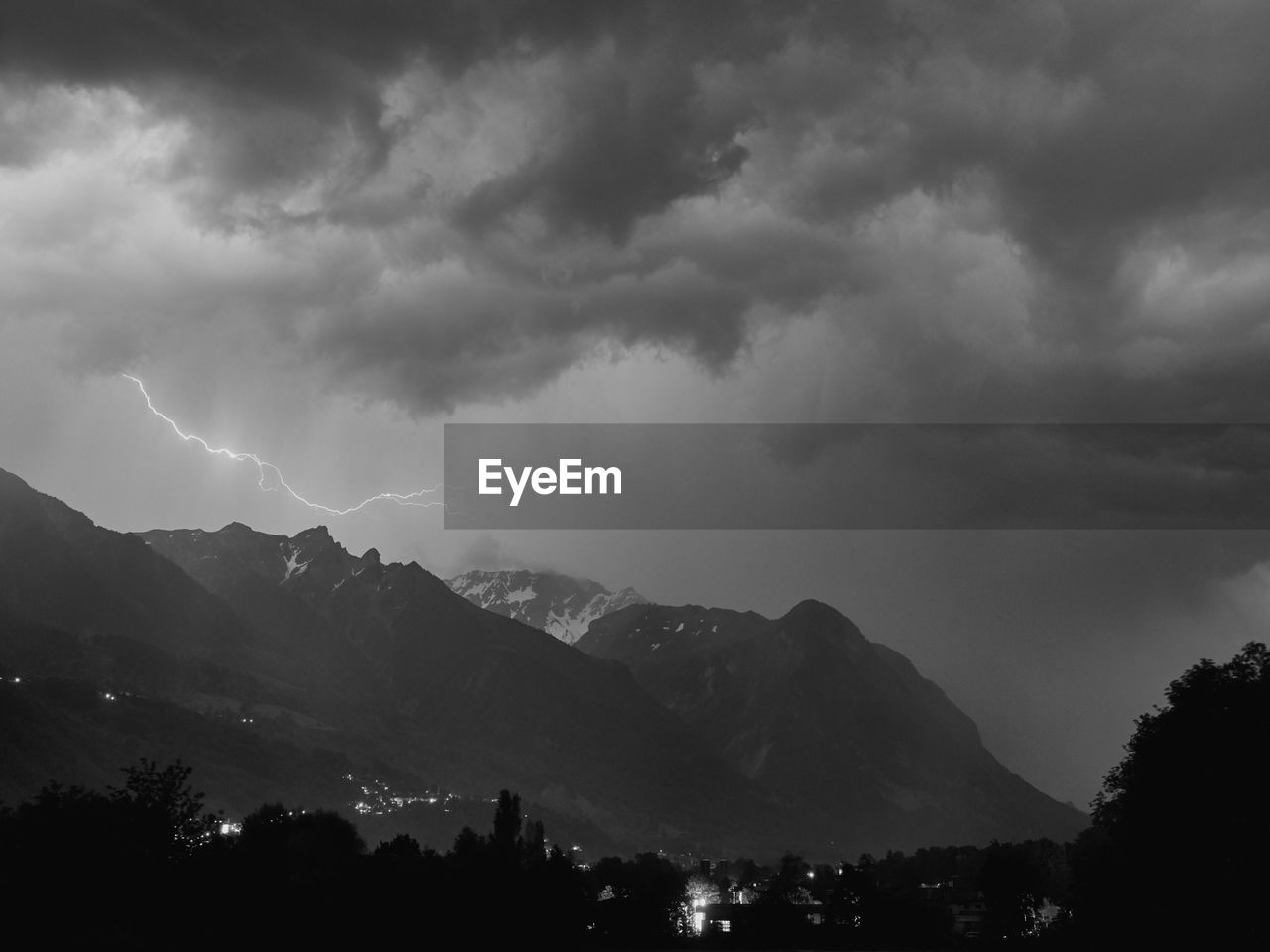 Scenic view of mountains against cloudy sky