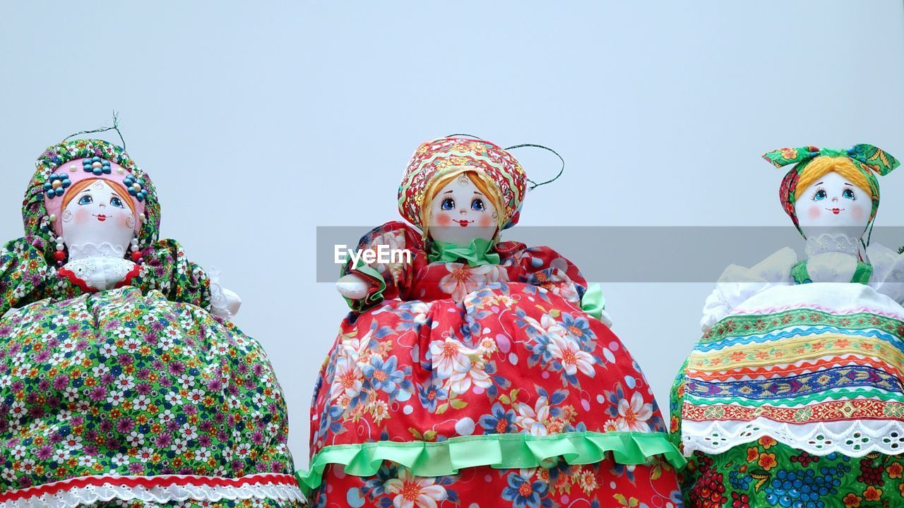 Close-up of stuffed toy against sky over white background