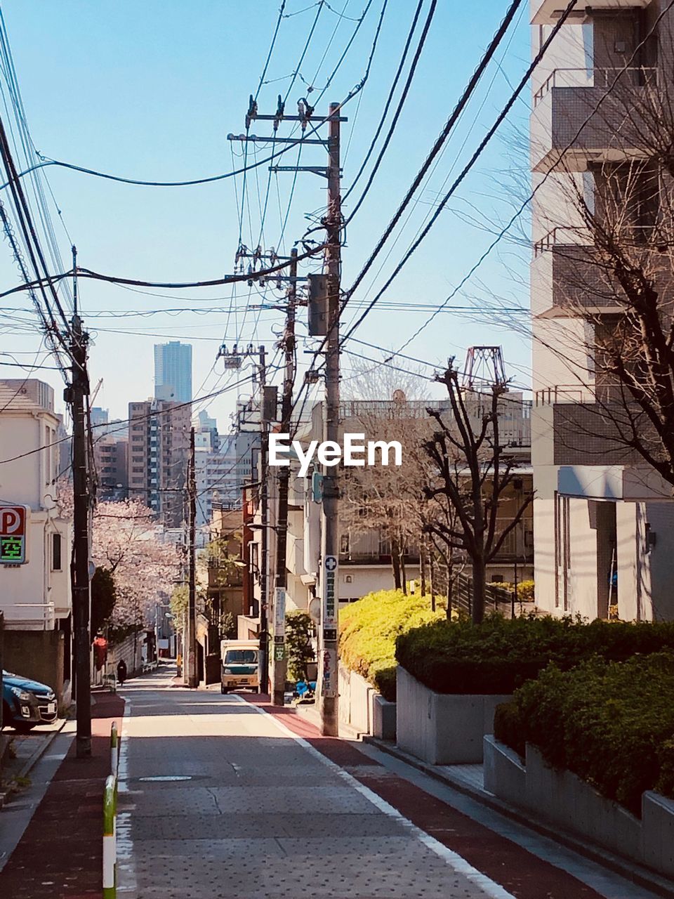 STREET AMIDST BUILDINGS AGAINST SKY