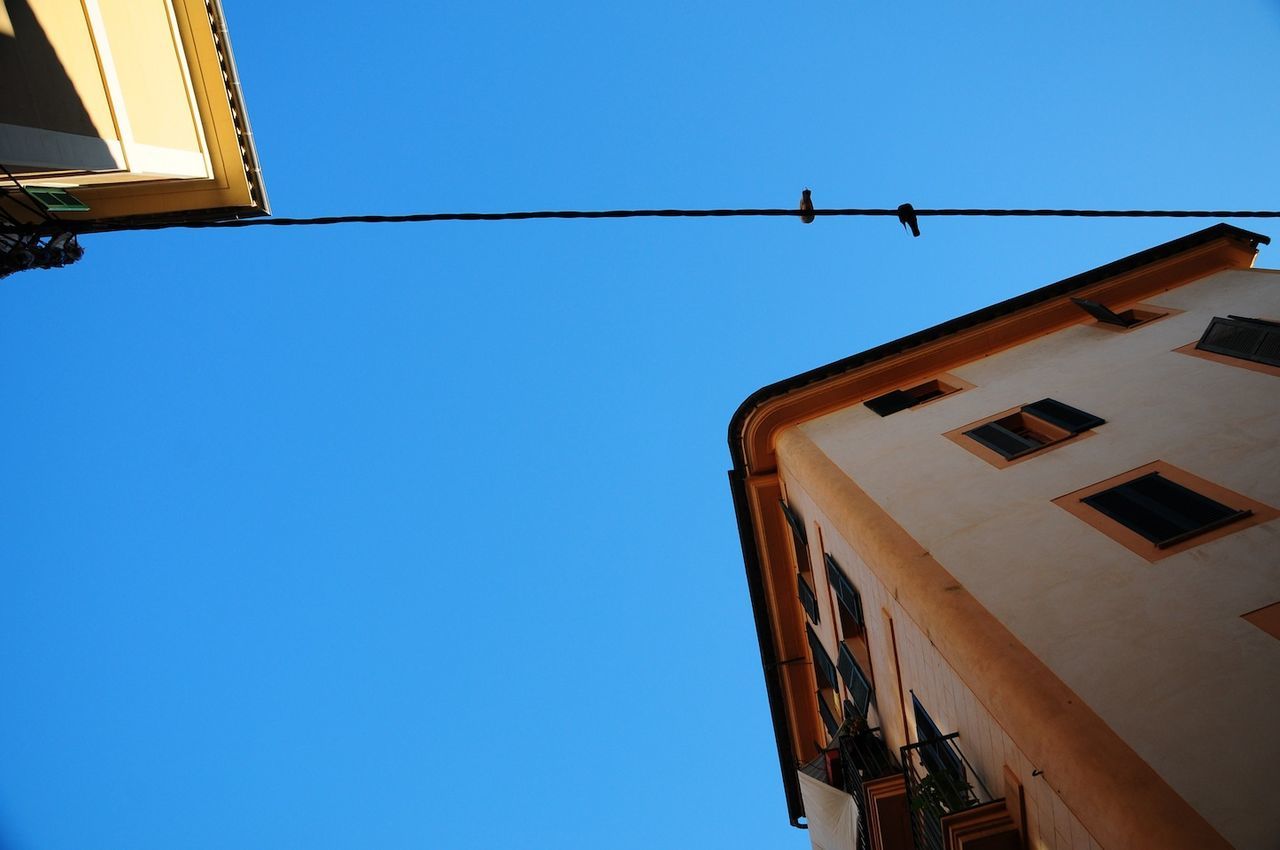 Low angle view of buildings against blue sky