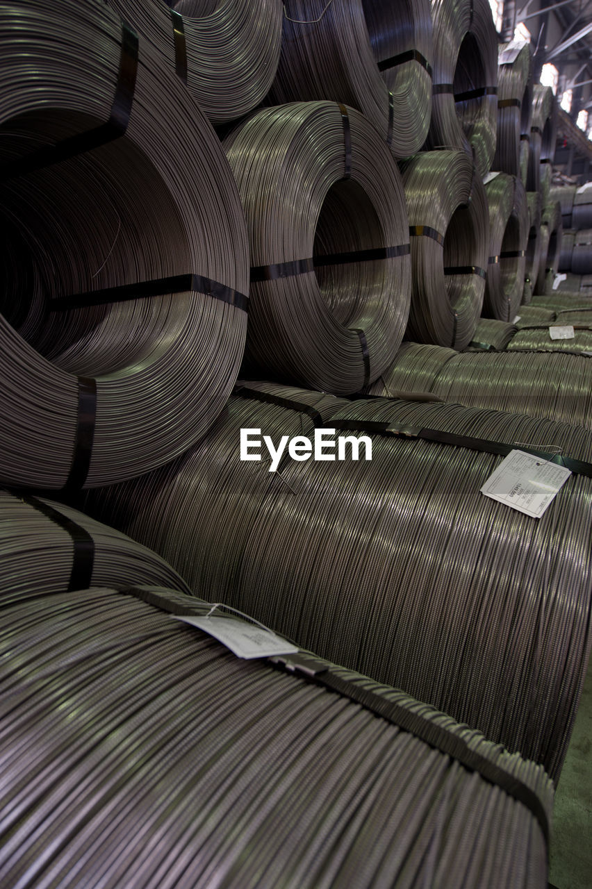 Full frame shot of metallic rolled up wires at steel plant
