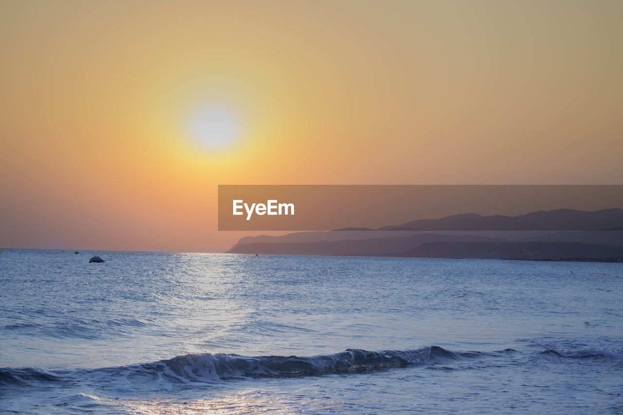 SCENIC VIEW OF SEA AGAINST ORANGE SKY