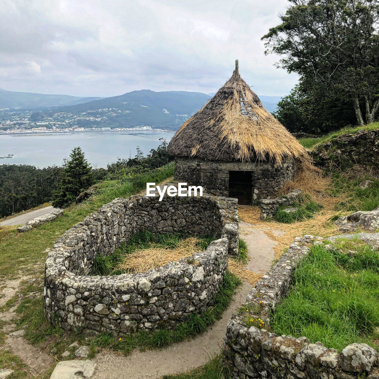 TILT IMAGE OF STONE WALL WITH MOUNTAIN IN BACKGROUND