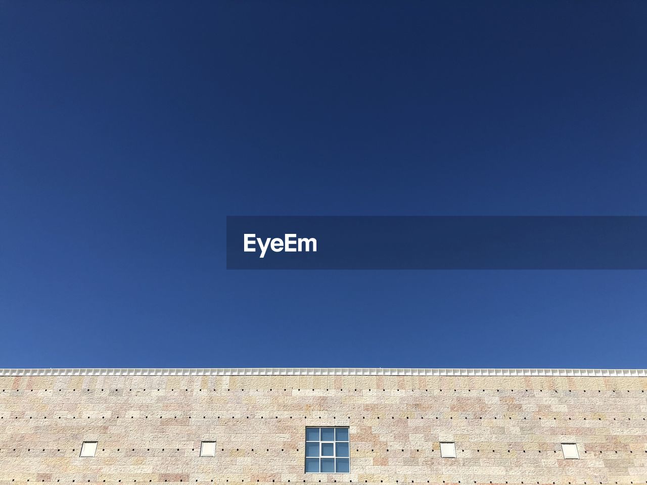 Low angle view of building against blue sky