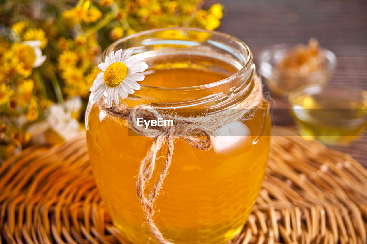 CLOSE-UP OF GLASS JAR ON TABLE