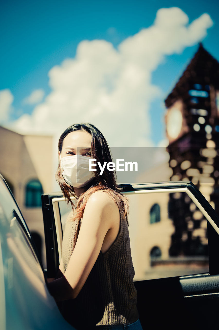 Young woman open car door and prepare to enter the car