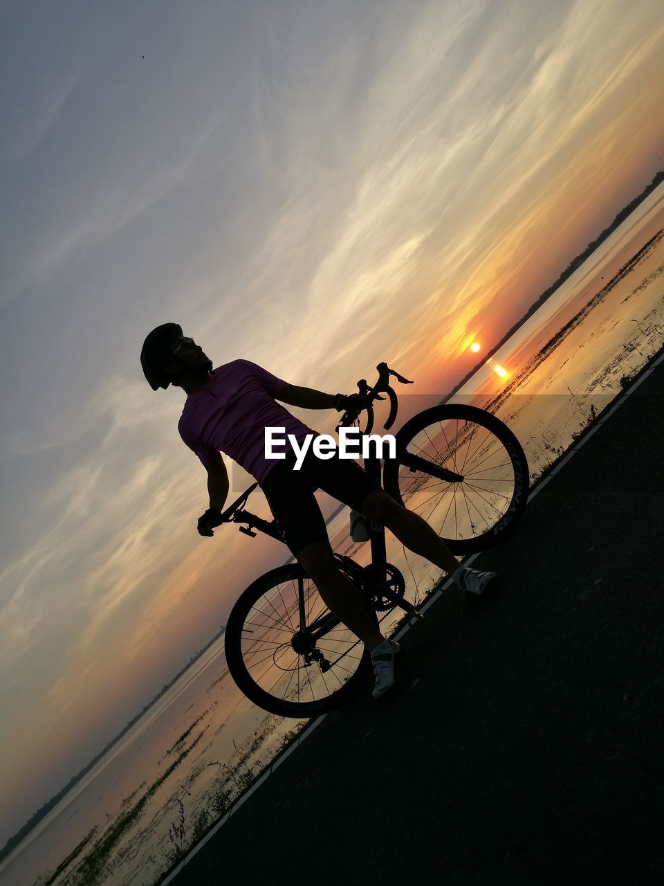 LOW ANGLE VIEW OF BICYCLE ON ROAD AGAINST SKY