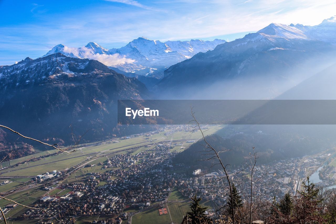 Aerial view of townscape against mountain range