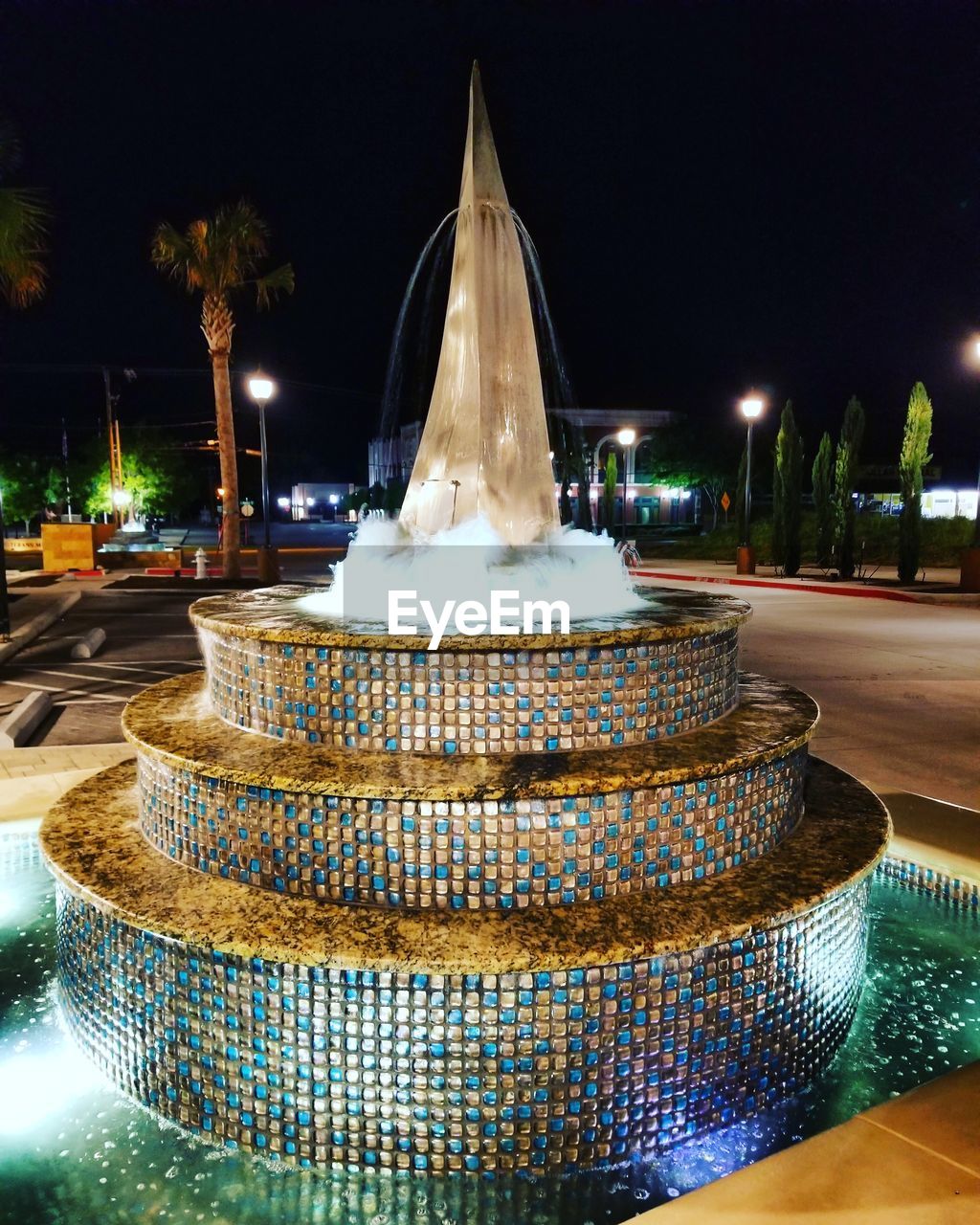 ILLUMINATED FOUNTAIN IN BUILDING AT NIGHT