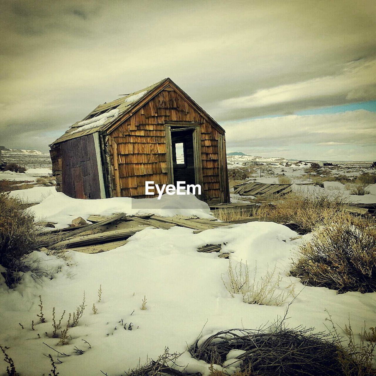 HOUSES ON SNOW COVERED LANDSCAPE