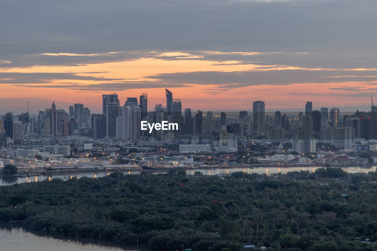 MODERN BUILDINGS AGAINST SKY DURING SUNSET