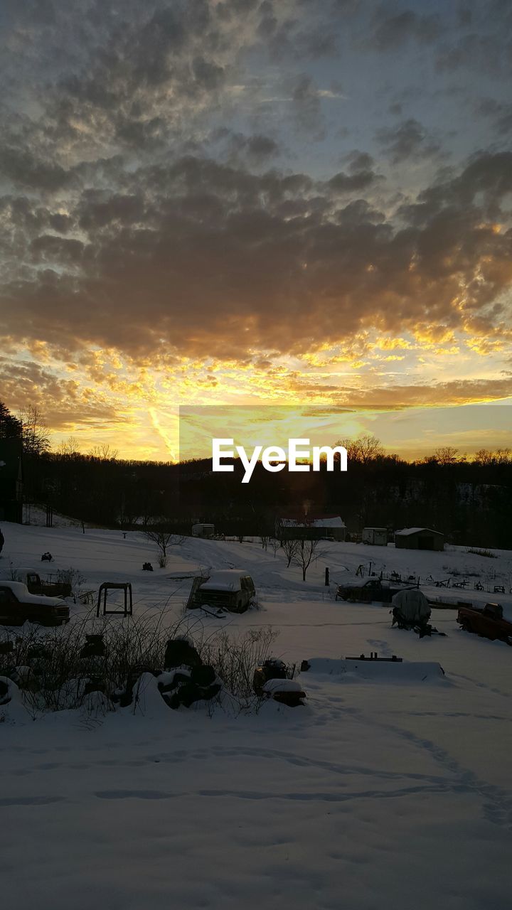 SNOW COVERED LANDSCAPE AT SUNSET