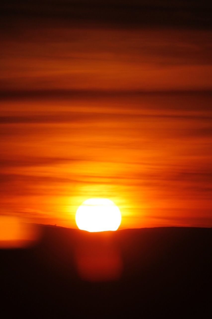 Idyllic shot of silhouette mountain against orange sky during sunset