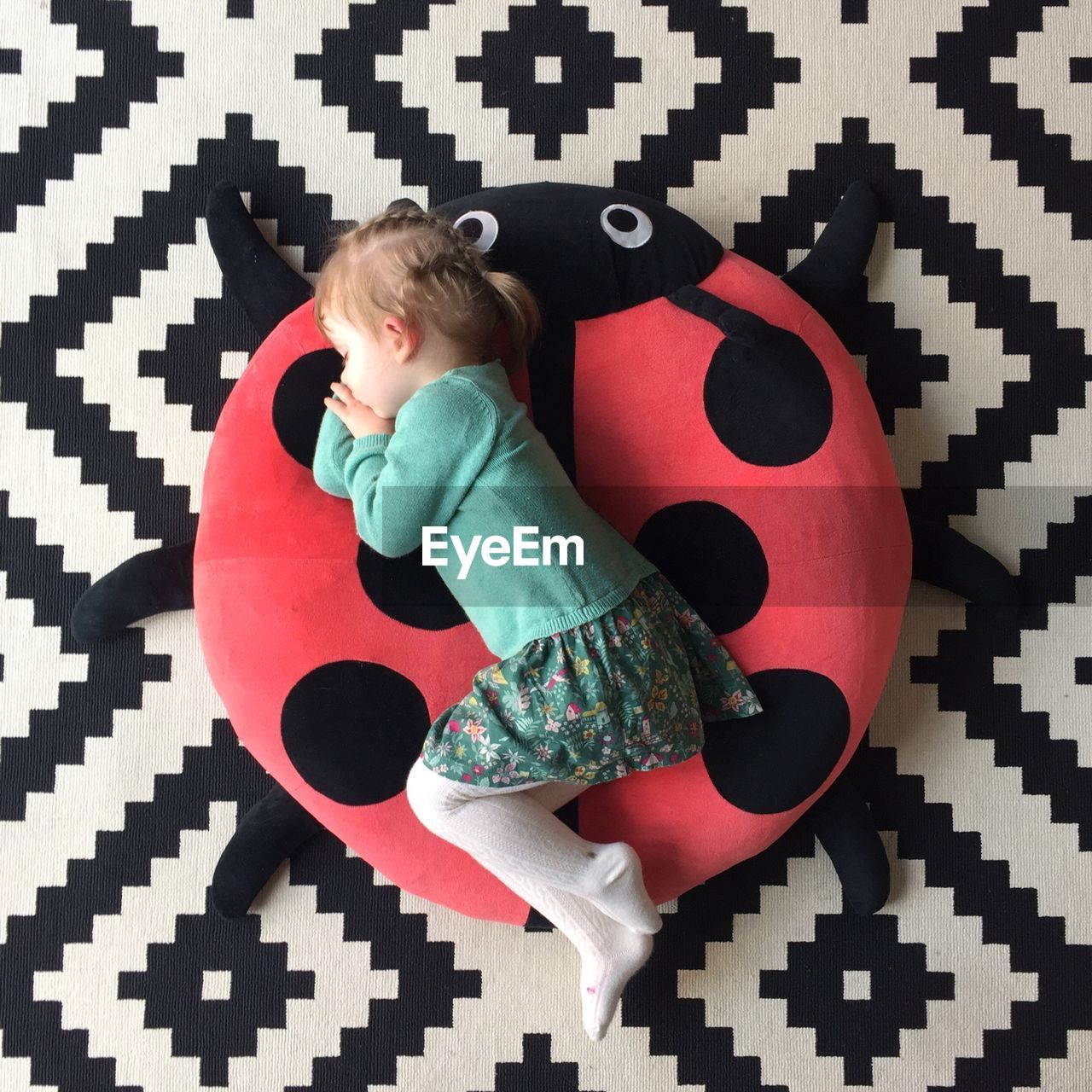 Directly above shot of girl sleeping on seat