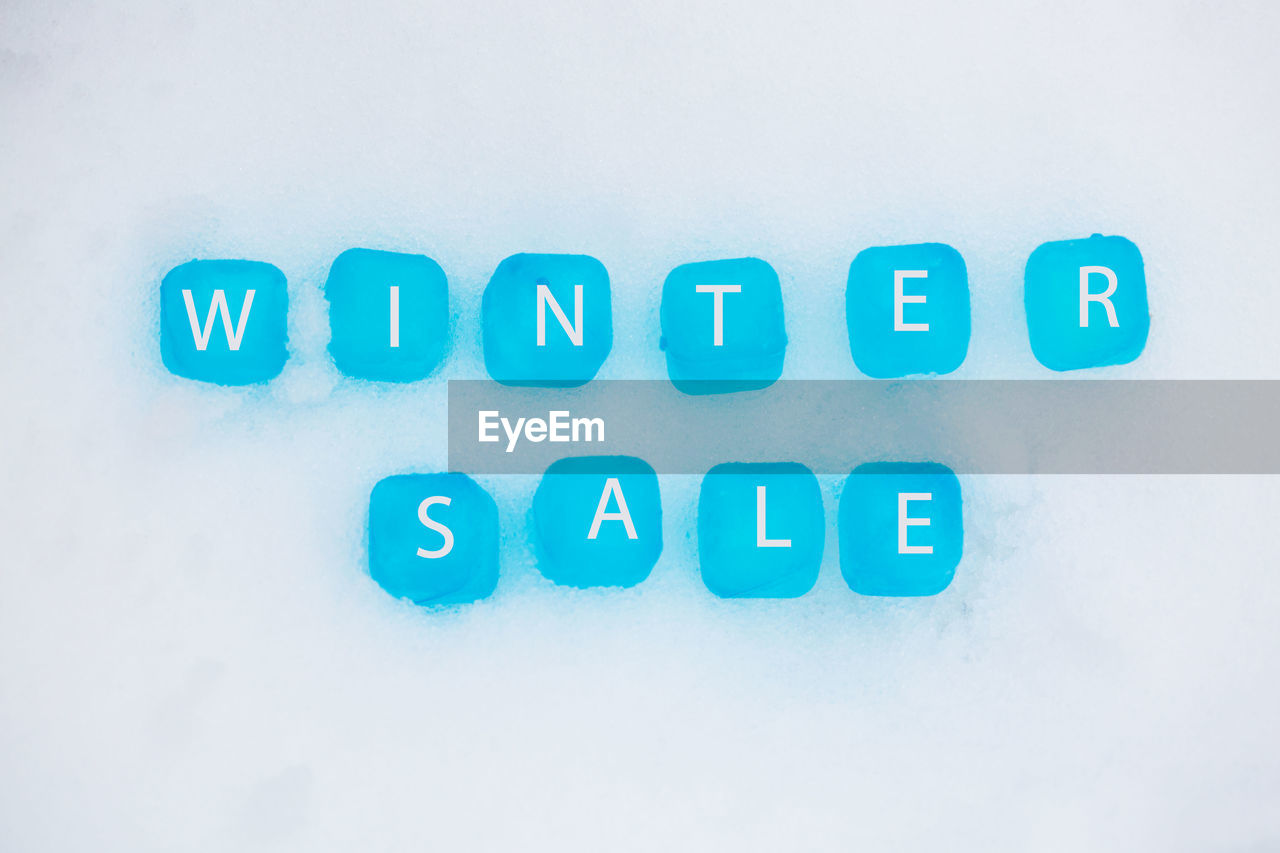 Directly above view of winter sale text on snow