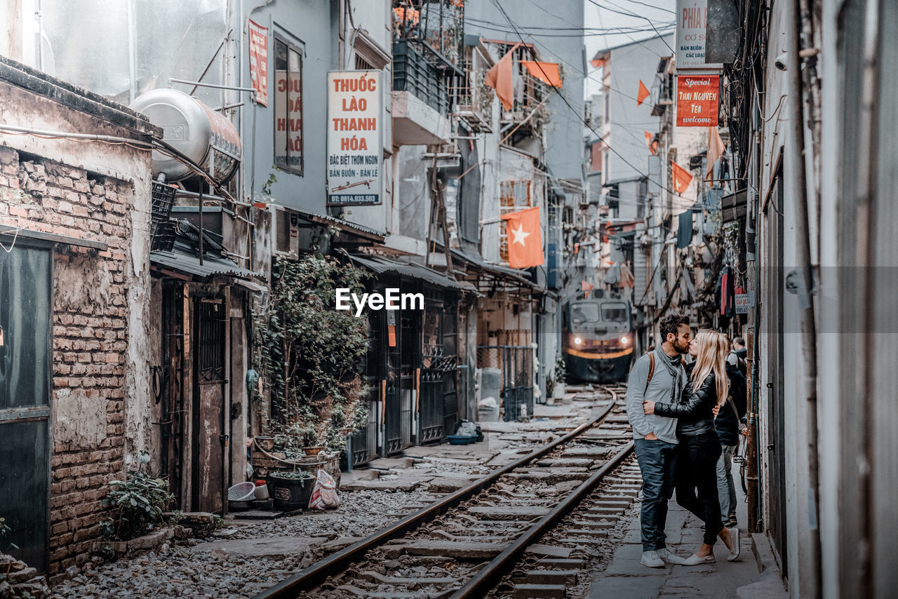 RAILROAD TRACKS BY BUILDINGS IN CITY