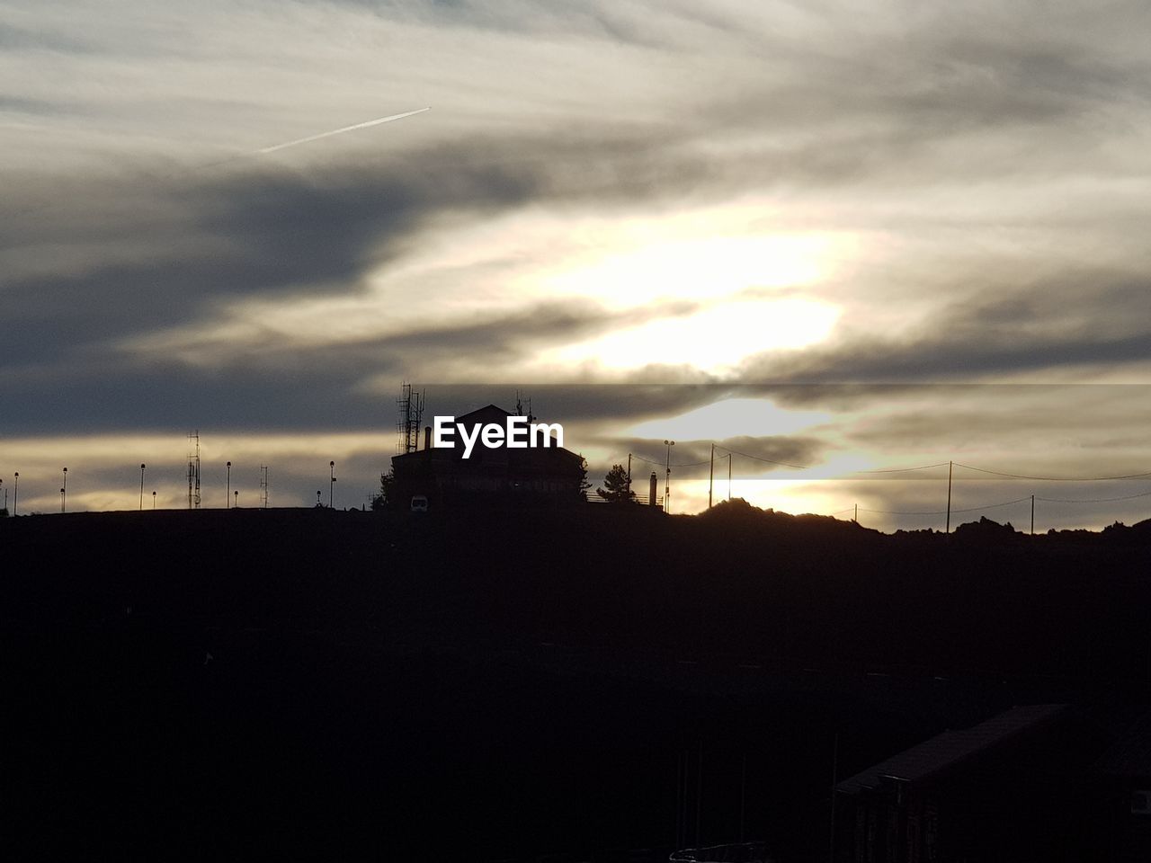 SILHOUETTE BUILDING AGAINST SKY AT SUNSET