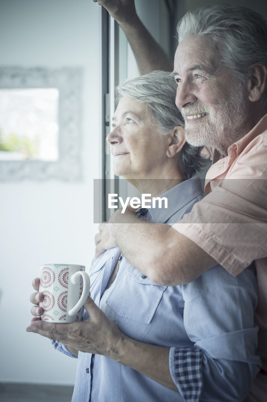 MAN WITH WOMAN HOLDING CAMERA